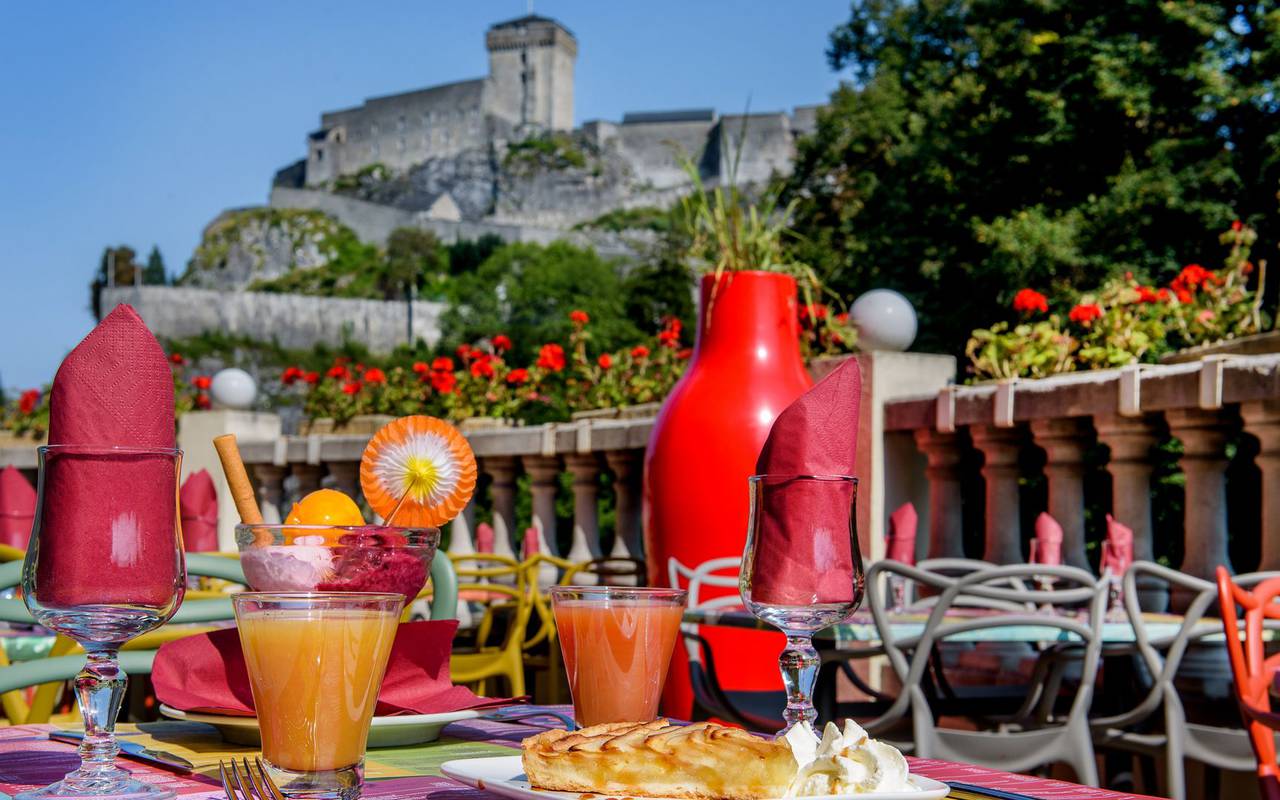 Cocktails on our colorful tables on the terrace overlooking the castle, brasserie lourdes, Hotel La Solitude.