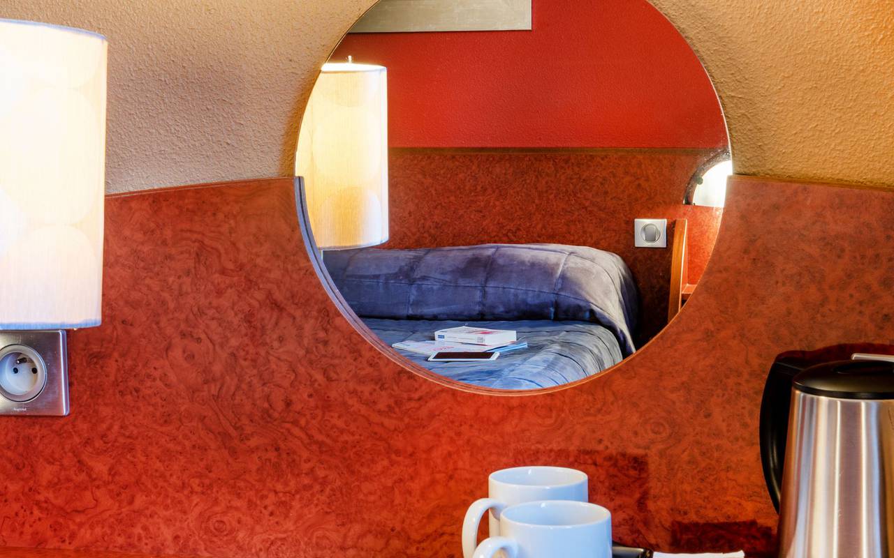 Reflection of the double bed in the mirror of the room with balcony, hotel restaurant lourdes, hotel La Solitude.