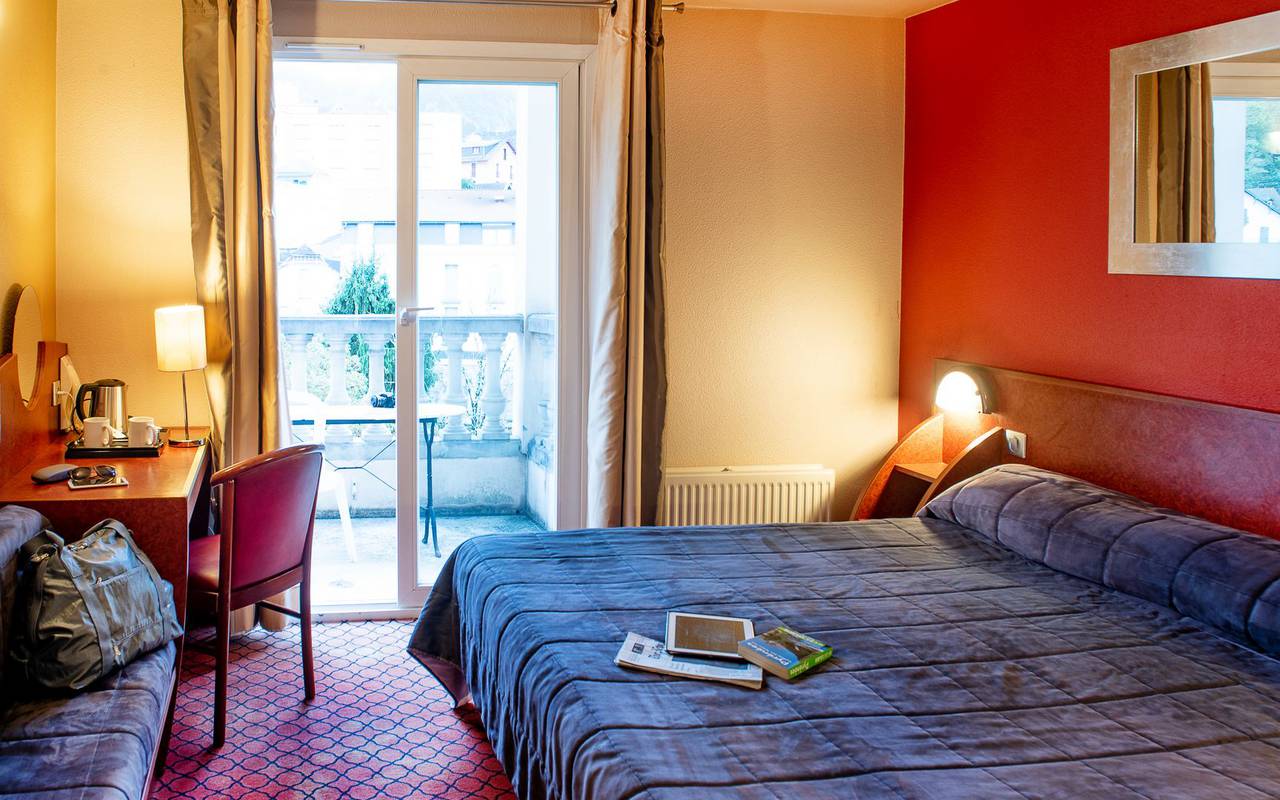 Large double bed in the duplex room with desk, lourdes travel, hotel La Solitude.